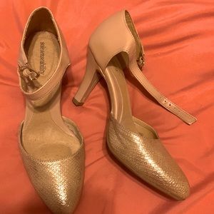 Gold and beige heels. It’s a pump but buckles.